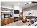 Spacious living area featuring a fireplace, built-ins, and a large TV at 3224 E Desert Cove Ave, Phoenix, AZ 85028