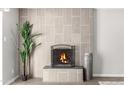 Modern fireplace with a gray tile surround and black metal screen at 331 E Pierce St, Tempe, AZ 85288