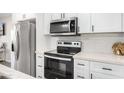Modern kitchen with white cabinets, stainless steel appliances, and white countertops at 331 E Pierce St, Tempe, AZ 85288