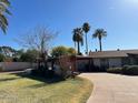 Ranch style home with carport and landscaping at 4461 E Flower St, Phoenix, AZ 85018