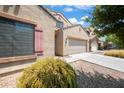 Two-story house with a large driveway and landscaping at 5677 S 239Th Dr, Buckeye, AZ 85326