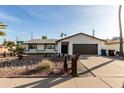 Ranch style home with a landscaped front yard at 6801 S Palm Dr, Tempe, AZ 85283