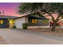Mid-century modern home with a white brick facade and black accents at 8601 E Roanoke Ave, Scottsdale, AZ 85257