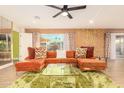 Bright living room with orange sectional sofa and unique decor at 8601 E Roanoke Ave, Scottsdale, AZ 85257
