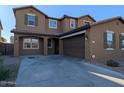 Two-story house with a two car garage and desert landscaping at 12029 W Overlin Ln, Avondale, AZ 85323