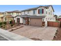 Two story house with a three car garage and brick driveway at 18407 W Fulton St, Goodyear, AZ 85338