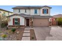 Two story house with a three car garage and brick driveway at 18407 W Fulton St, Goodyear, AZ 85338
