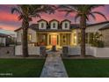 Front view of a beautiful home with palm trees and a walkway at 19702 E Melissa Pl, Queen Creek, AZ 85142