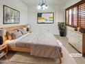 Main bedroom with a king-size bed and wood flooring at 5221 W Sandra Ter, Glendale, AZ 85306