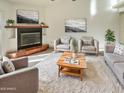 Bright living room featuring a fireplace and comfy seating at 5221 W Sandra Ter, Glendale, AZ 85306