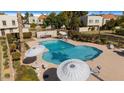 Inviting community pool with ample seating and umbrellas at 7925 E Keim Dr, Scottsdale, AZ 85250