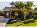 Charming home with a wood pergola and well-manicured lawn at 905 E Weldon Ave, Phoenix, AZ 85014