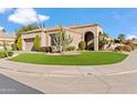 One-story house with artificial turf and a curved driveway at 9137 N 116Th Pl, Scottsdale, AZ 85259