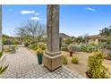 Landscaped front yard with desert plants and a stone pathway at 11526 E Diamond Cholla Dr, Scottsdale, AZ 85255