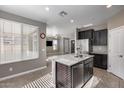 Granite island kitchen with stainless steel appliances and breakfast bar at 1255 N Arizona Ave # 1276, Chandler, AZ 85225