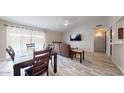 Bright living room with hardwood floors, a dining area, and a brown leather couch at 15420 N 160Th Ln, Surprise, AZ 85374