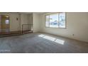 Bright living room with large window and view of the street at 232 E Woodman Dr, Tempe, AZ 85283