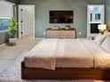 Main bedroom with ensuite bathroom and large TV at 2522 W Brisa Dr, Phoenix, AZ 85085