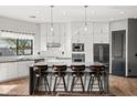 Modern kitchen with white cabinets, island, and stainless steel appliances at 28919 N 153Rd Ave, Surprise, AZ 85387