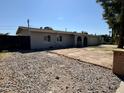 Ranch style home with a large gravel driveway and a fenced yard at 3617 W Harmont Dr, Phoenix, AZ 85051