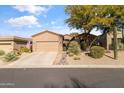 Tan stucco house with two-car garage and desert landscaping at 7438 E Soaring Eagle Way, Scottsdale, AZ 85266