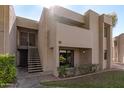 Front view of tan condo with stairs and entrance at 1920 W Lindner Ave # 147, Mesa, AZ 85202