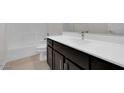 Clean bathroom with dark vanity and white countertop at 2518 N Pony Ln, Casa Grande, AZ 85122