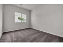 Bright bedroom with neutral carpeting and large window at 2518 N Pony Ln, Casa Grande, AZ 85122