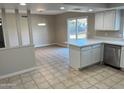 Kitchen with island, stainless steel appliances, and access to backyard at 3946 W Cholla St, Phoenix, AZ 85029