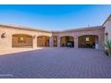 Spacious three-car garage with brick exterior and ample parking space at 5681 E Canyon Ridge North Dr, Cave Creek, AZ 85331