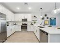 Modern kitchen with white cabinets, stainless steel appliances, and a large island at 7641 W Minton St, Laveen, AZ 85339