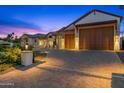 Large wooden garage doors and a paved driveway at 11438 N 70Th St, Scottsdale, AZ 85254