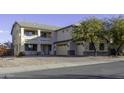 Two-story house with a three-car garage and a gravel driveway at 1340 E Kingman Pl, Casa Grande, AZ 85122