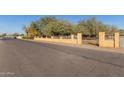 Residential street with a tan colored wall at 1340 W Romley Rd, Phoenix, AZ 85041