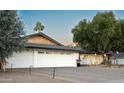 Modern two-car garage with a clean, white exterior and landscaping at 1440 E Secretariat Dr, Tempe, AZ 85284