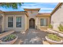 Courtyard entry with double doors and planters, leading to the entrance of a tan house at 40718 N Copper Basin Trl, Phoenix, AZ 85086