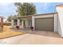 House exterior showcasing a covered entryway and attached garage at 409 Leisure World --, Mesa, AZ 85206