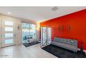 Bright living room with modern furniture and red accent wall at 4444 N 25Th St # 15, Phoenix, AZ 85016