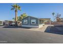 Single-wide manufactured home with carport and desert landscaping at 549 E Mckellips Rd # 44, Mesa, AZ 85203