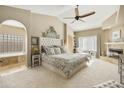 Large main bedroom with a luxurious bed, fireplace and ensuite bathroom at 8689 E Windrose Dr, Scottsdale, AZ 85260