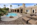 Inviting kidney-shaped pool with surrounding patio and lounge chairs at 8689 E Windrose Dr, Scottsdale, AZ 85260