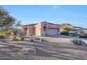 One-story home with desert landscaping and two-car garage at 11595 E Christmas Cholla Dr, Scottsdale, AZ 85255