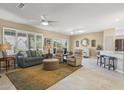 Spacious living room with tile floors, comfy seating and a large TV at 16824 W Palisade Trail Ln, Surprise, AZ 85387