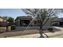 Single story home with a front yard and desert landscaping at 17913 W Desert View Ln, Goodyear, AZ 85338
