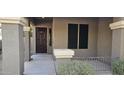 Front entry with a dark brown door and sidelights at 17913 W Desert View Ln, Goodyear, AZ 85338
