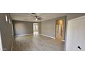 Spacious living room with light wood floors and neutral walls at 17913 W Desert View Ln, Goodyear, AZ 85338