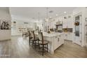 Modern kitchen with white cabinets and center island at 30277 N 115Th Ln, Peoria, AZ 85383