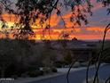 Residential home with sunset view and mountain backdrop at 10803 E La Junta Rd, Scottsdale, AZ 85255