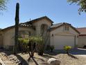 Charming one-story home with a two-car garage and cacti at 3949 E Monona Dr, Phoenix, AZ 85050