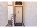 Front entrance with a light beige door and welcome sign at 3949 E Monona Dr, Phoenix, AZ 85050